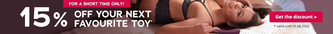 A woman wearing black lingerie can be seen on the advertisement. She is lying on her back on a bed and looking to the side. She is holding a sex toy in her hand. The large white text says: “15% off your favourite toy”. There is a red button at the top with the words “For a short time only”.