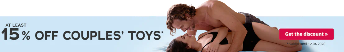 A topless man is lying on a woman. Both are smiling at each other. The woman is wearing black underwear and is lying on a light blue bedsheet. The text: “At least 15% off couple’s toys – valid until 12.04.2026” is written in large letters.
