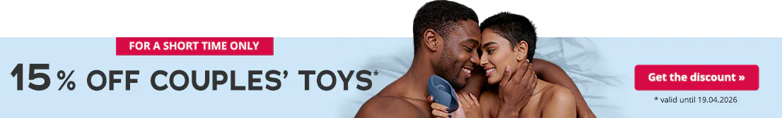A couple lie entwined on a bed with blue bedding. They are smiling at each other. Both are topless. The woman is holding a dark blue masturbator in her hand. There is some text on the left-hand side that is written in large black letters. The text says: “15% off couples’ toys*”. There is some smaller text below that says: “* valid until 19.04.2026”.
