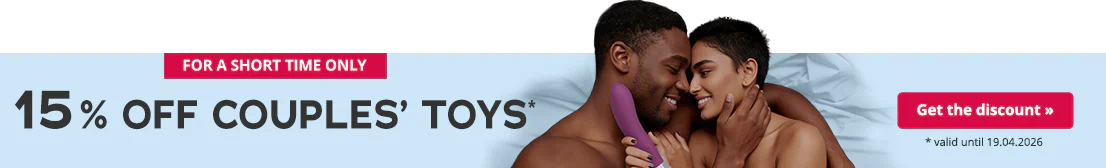 A couple lie entwined on a bed with blue bedding. They are smiling at each other. Both are topless. The woman is holding a purple vibrator in her hand. There is some text on the left-hand side that is written in large black letters. The text says: “15% off couples’ toys*”. There is some smaller text below that says: “* valid until 19.04.2026”.