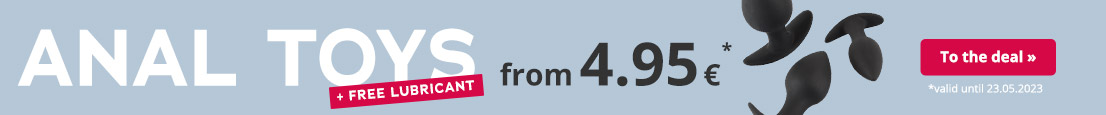 The advertisement has a light blue background with white text that says “ANAL TOYS” and “from €4.95” in black letters. There is a red banner above this with red text that says “+ FREE LUBRICANT”. Black anal toys are partially visible in the background.