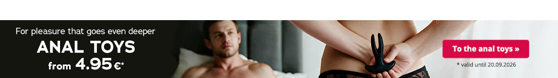 A naked woman. Her dark blonde hair can be seen. She is holding an anal toy behind her back with both hands. A man is lying on the bed in front of her. There is some large text that says: “For pleasure that goes even deeper – anal toys from 4.95€ ”. There is a button with the text "To the anal toys >>".