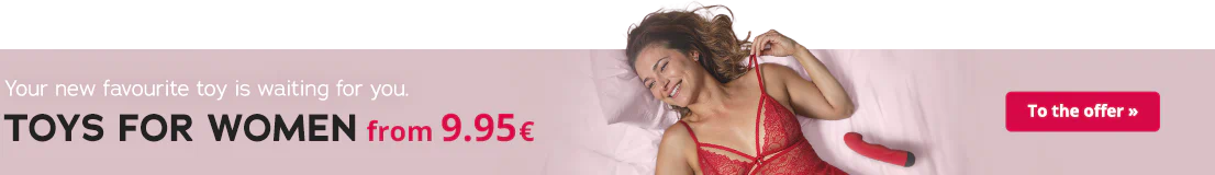 A smiling woman is lying on pink bed linen. She is wearing red lace lingerie and a transparent babydoll. A red & black vibrator is next to her hip. Text: “Your new favourite toy is waiting for you” and “TOYS FOR WOMEN from 9.95€”.