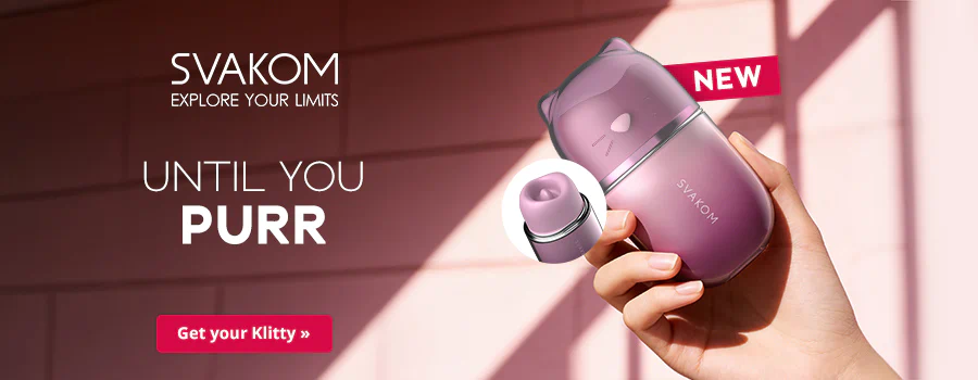 A purple, cat-shaped sex toy with small ears is being held in front of a pink wall by a hand. There is a small round image next to it showing the inside of the toy. There is some white text on the left-hand side that says: “SVAKOM – Explore your limits” and “UNTIL YOU PURR”. There is also a red banner in the top right corner that says: “NEW”. There is a red button at the bottom with some white text that says: “Get your Klitty”.