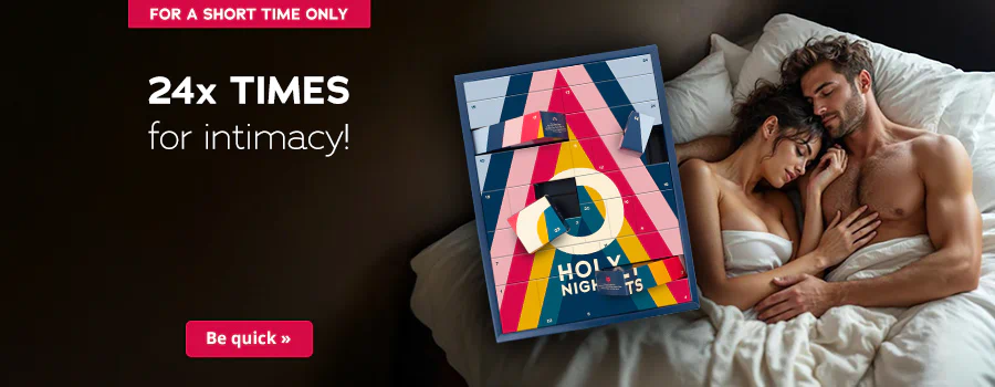 There is a couple shown on the advertisement. A man and a woman are lying in bed, both of them are topless. The woman is lying with her head on the man's chest and both of them have their eyes closed. The Advent calendar in a colourful design and the text “HOLY NIGHTS” are prominently displayed. The sentence: “24x times for intimacy!” can be seen above this in white letters. There is a red banner at the top with the words “Only while stocks last”. There is another red banner at the bottom with the words “Be quick »”.