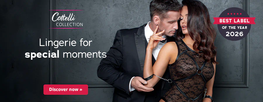 A man in a black suit is standing behind a woman wearing black lace lingerie. His head is touching her face. “Lingerie for special moments” is written in large letters. There is also a red “Discover now” button below it. There is a round eye-catcher next to the couple that says “Best Label of the Year 2026”.