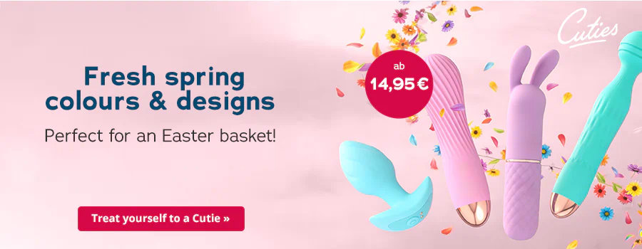 The advertisement has a pink background. The text at the top says “Fresh spring colours & designs”. The “Cuties” logo can be seen next to the text. Four different products can be seen in the middle of the advertisement. The products are in pastel colours. There is a red circle next to them with the text “from 14.95 €”. Colourful petals and small flowers are scattered around the products. There is a red button at the bottom that says “Treat yourself to a Cutie”.