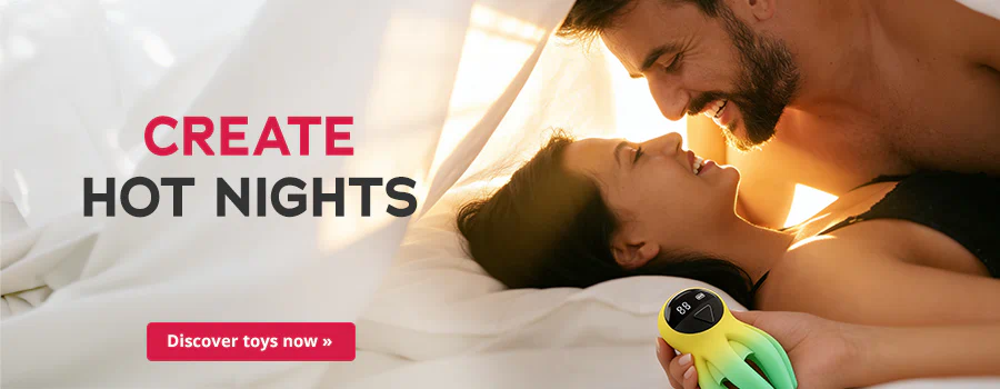 Advertisement banner featuring a smiling couple in bed. One of them is holding a green and yellow toy in their hand. The man is topless and the woman is wearing a black top. Text: “Create hot nights” and a button saying “Discover toys now”
