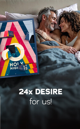 The advertisement is showing a topless man lying arm in arm with a woman wearing a white top. The two are looking at each other and smiling. The Advent calendar with a colourful design and the text "HOLY NIGHTS" is prominently displayed. "24x desire for us" is written in white letters.