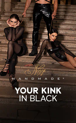 The advertisement is of three people sitting on a staircase. There is a man sitting in the middle wearing a black outfit with a mask and leather harness. There is a woman to his left. She is kneeling. There is another woman to his right and she is sitting down. Both women are wearing black, skin-tight and slightly transparent outfits. Both women have gold-coloured collars with leashes. The man is holding their leashes. The words “Your kink in black” are written in large letters. The golden "Noir Handmade" logo can also be seen on the advertisement. There is a red button at the bottom with the text “Discover Noir now”.