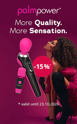 Banner for Palm Power featuring a pink and black massage wand and a mini massage wand against a dark purple background. There is a woman with curly hair on the right-hand side. She is wearing glasses and a red top. Text: “More Quality. More Sensation.”, “-15%*” and “valid until 23.10.2026”. There is also a red button with the text: “Find your favourite toy »”.